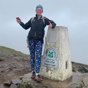 Chris Farr on the summit of Sugar Loaf, smiling in the cloud