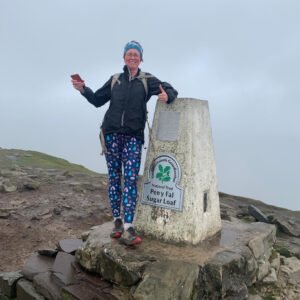 Chris Farr, MDC Secretary, on top of Sugar Loaf by the trig point smiling